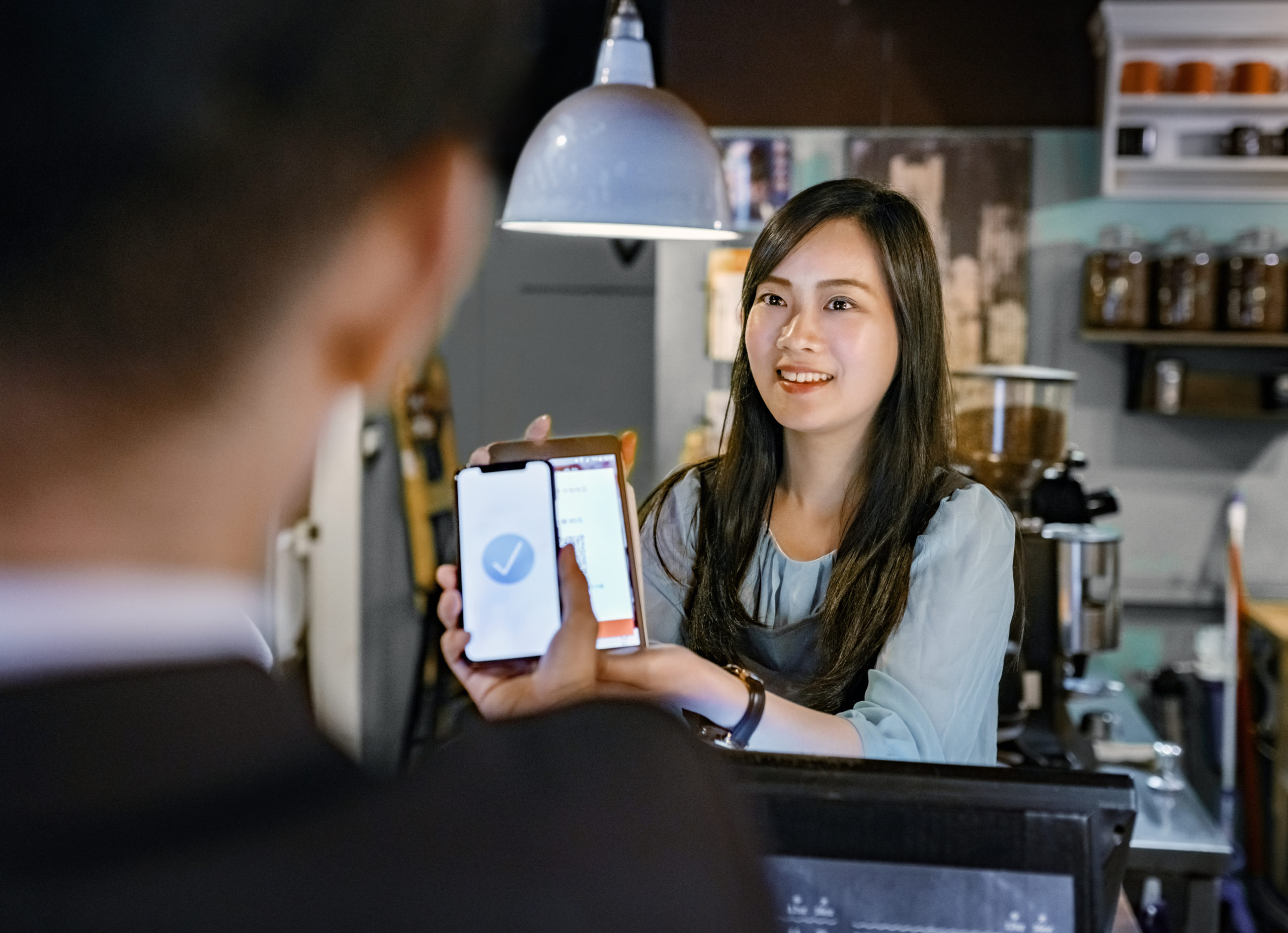 Customer paying through digital wallet at cafe
